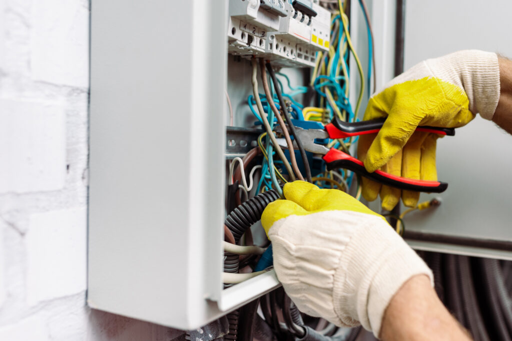 electrician working on a electrical panel after electrician SEO services gave them more leads