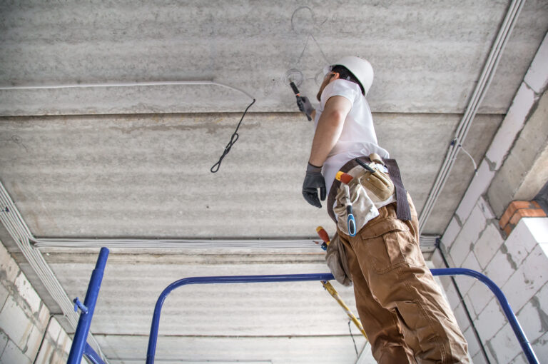 Commercial Electrician Fixing Wires in a Garage