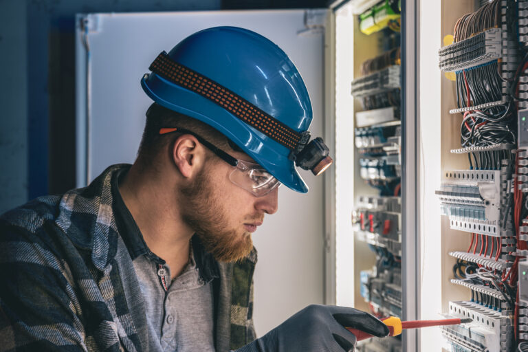 Emergency electrician repairing an electrical panel.