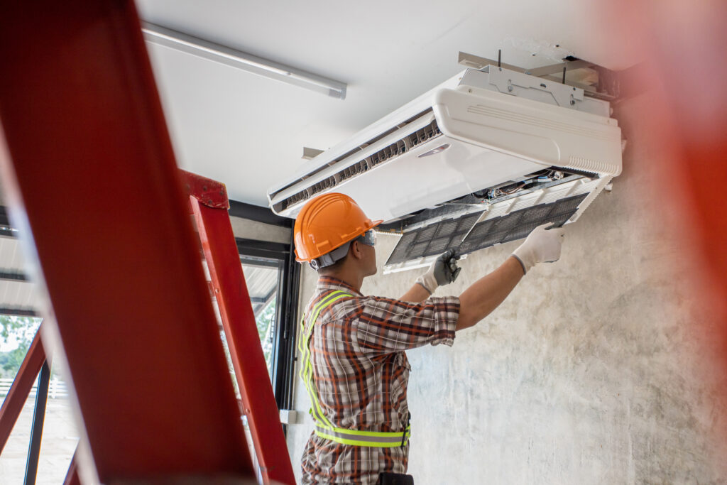 Technician installing air conditioning unit