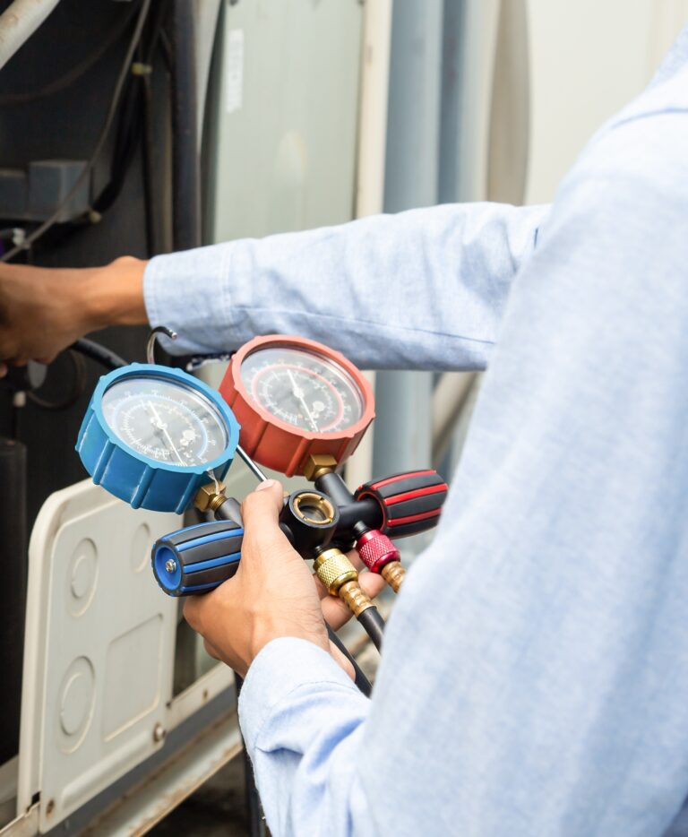 Technician using HVAC pressure gauges after Tampa HVAC SEO management secured him leads