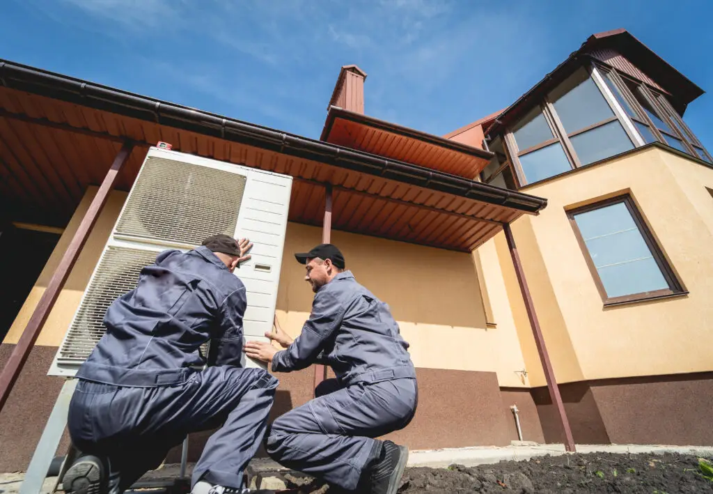 HVAC technicians servicing home heating and cooling system after Tampa HVAC website development services secured them leads.