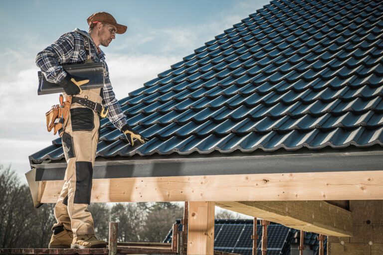 Male Caucasian Roofer Installing Roofing Tiles On Newly Built Home after Tampa roofing PPC services filled their schedule.