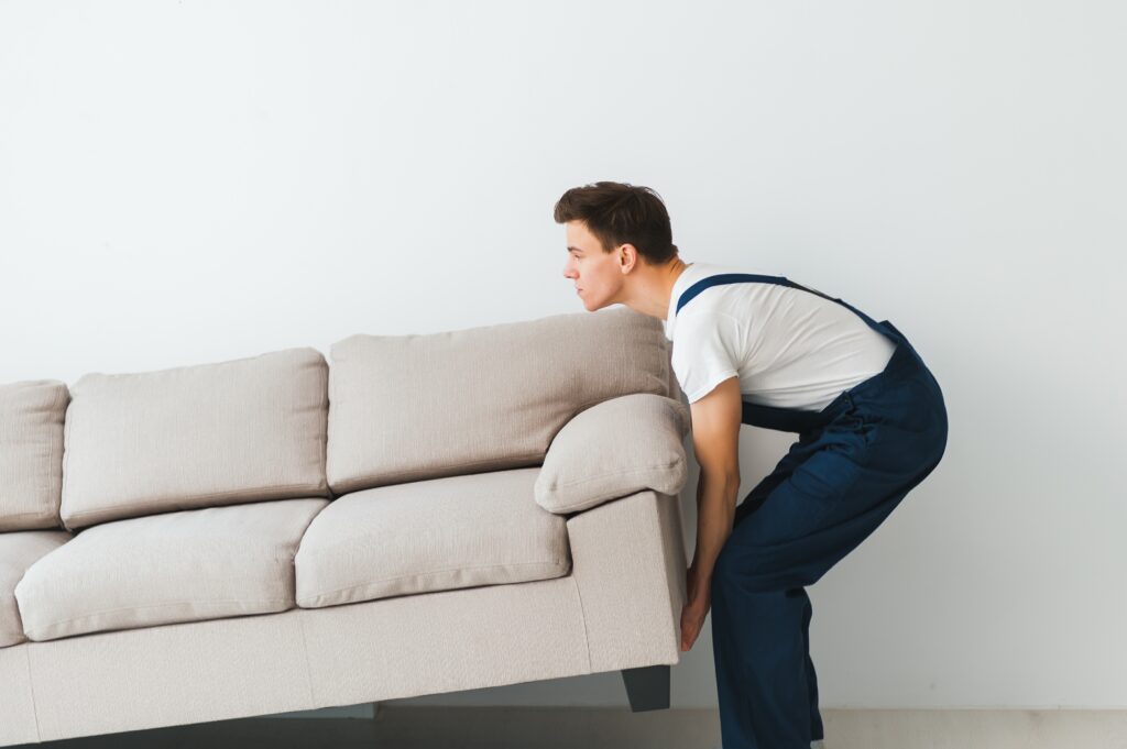 Man moving couch after tampa moving company digital marketing landed him tons of new work.