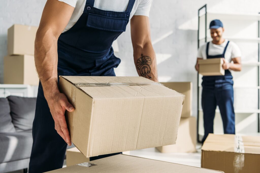 Man lifting moving box after digital market for tampa movers got him more business