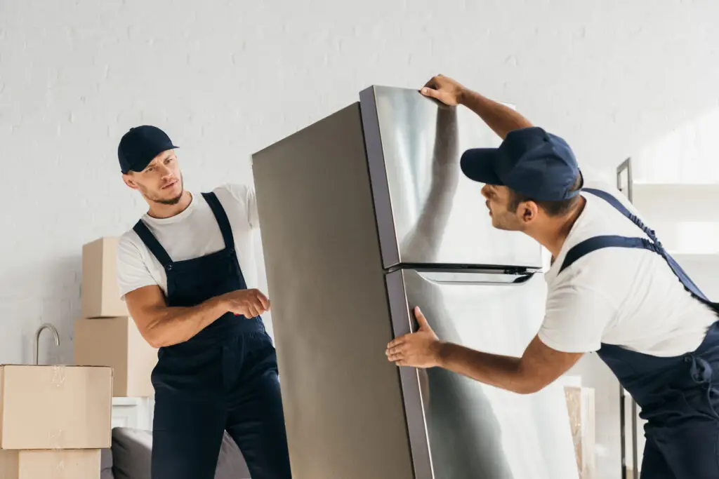 movers in uniform moving fridge in apartment after tampa moving company SEO filled their schedule