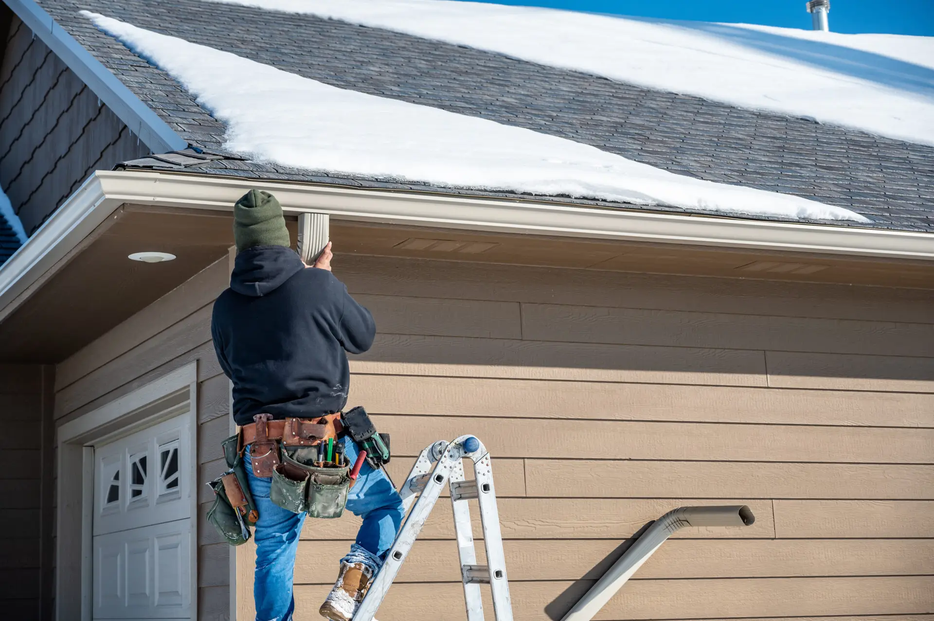 Gutter cleaning technician removing debris from a Tampa Bay residential gutter system — the recurring maintenance job that gutter SEO agency strategies in Tampa FL are built to generate consistently