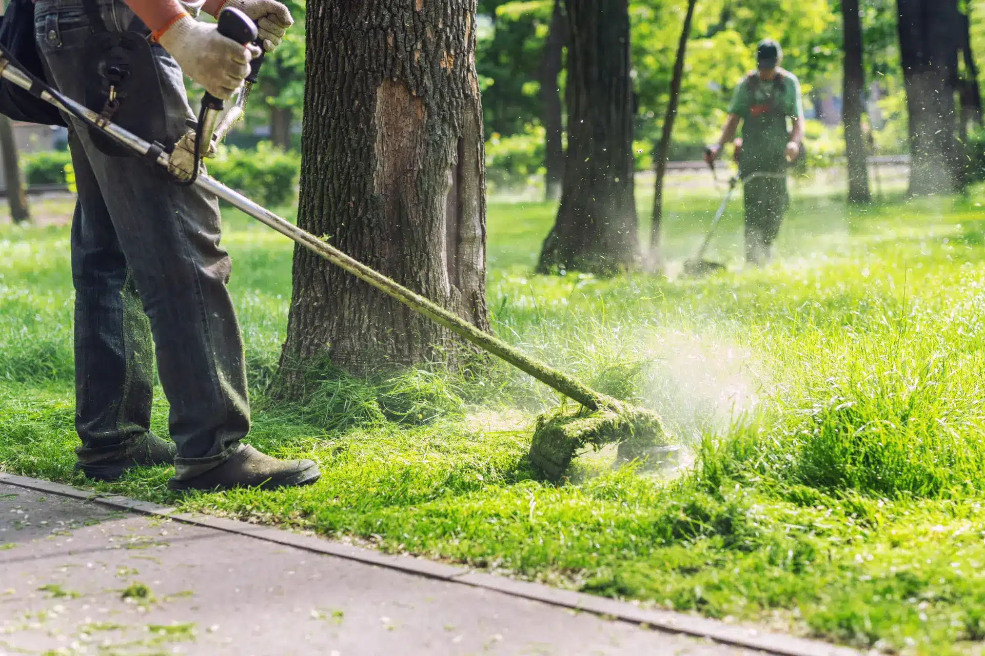 Landscaper trimming lawn — one contractor per trade per ZIP code