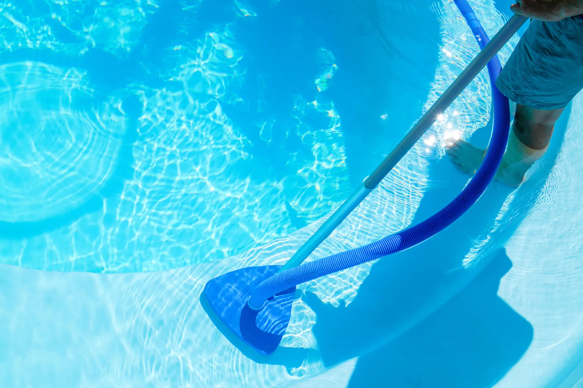 Pool and spa service technician checking equipment in a Tampa Bay backyard — the kind of recurring monthly client that SEO for pool service companies is built to attract