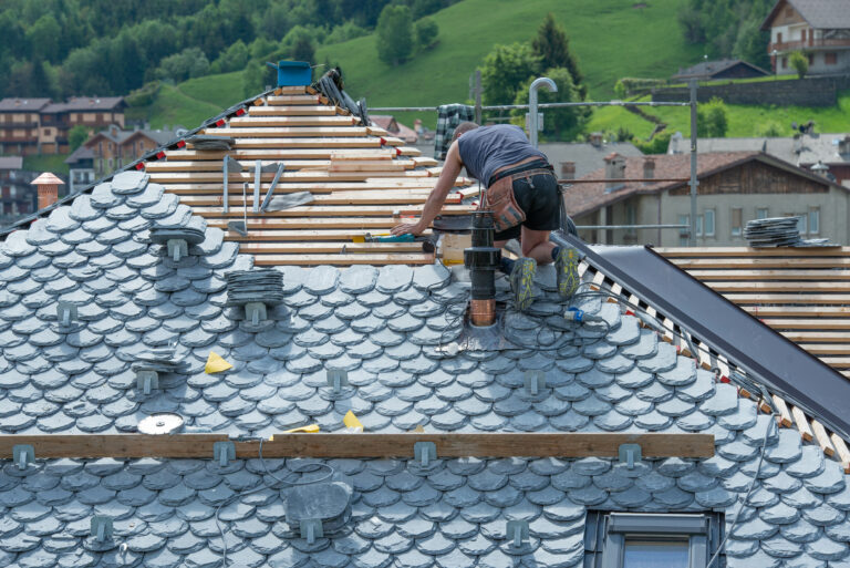 Roofers repairing a roof after securing roofing leads